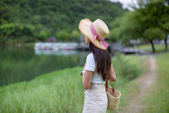 Woman stand beside the lake and look at the scenery view