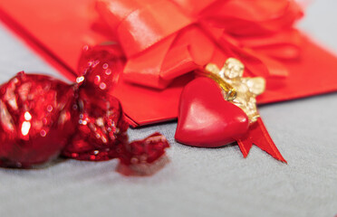 A gift in a red package with a heart and an angel. Valentine's day concept.