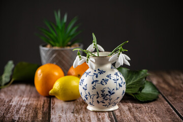 Arrangement with a snowdrop and a small vase