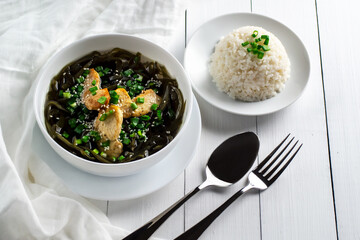 Korean cuisine. Healthy meals for pregnant women. Seaweed soup with meat in a white bowl. Birthday soup. Tradition. Custom.  Top view.