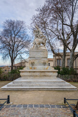 Fototapeta na wymiar Vertical view of the ancient white marble fountain of the unicorns or fontaine des licornes monument on Canourgue square, Montpellier, France