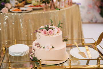 wedding cake with flowers on a trolley at a wedding