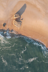 aerial photography of a wave in the sea and of the beach