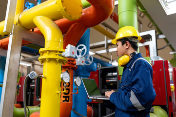 Maintenance technician at a heating plant,Petrochemical workers supervise the operation of gas and oil pipelines in the factory,Engineers put hearing protector At room with many pipes