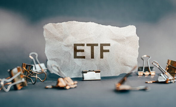 ETF text on the torn paper. ETF is short for Exchange Traded Fund