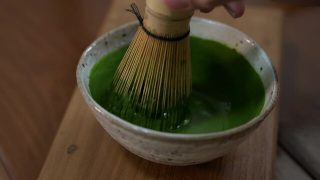 Chasen Bamboo Whisking Matcha green tea in the Bowl, Tea Ceremonial Traditional of Japanese