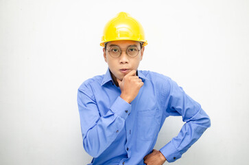 asian construction worker wearing yellow safety helmet shouting with shocked and surprised expression.
