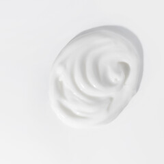White beauty cream smear smudge on white background. Cosmetic skincare product texture. Face cream, body lotion swipe swatch