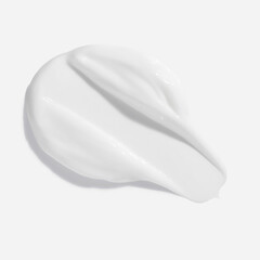Fototapeta premium White beauty cream smear smudge on white background. Cosmetic skincare product texture. Face cream, body lotion swipe swatch