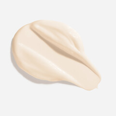 Beige beauty cream smear smudge on white background. Cosmetic skincare product texture. Face cream, body lotion swipe swatch