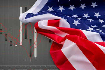Close-up of an American flag with a stock chart in the background. 