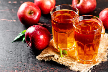 Fresh apple juice. Against a dark background.