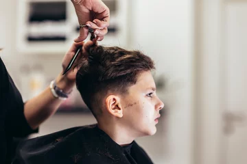  Cute young boy getting a haircut by hairdresser © Mediteraneo