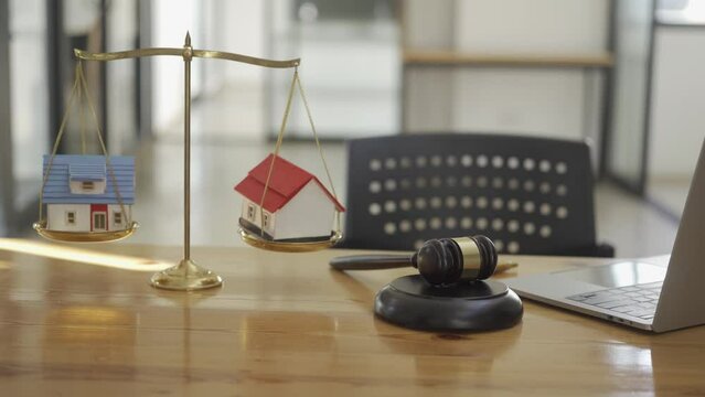 Real estate auction concept with house model and judge hammer scales for real estate foreclosure and home auction business judgment