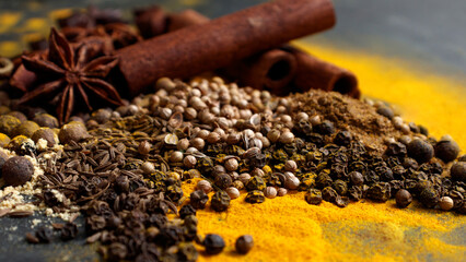 Oriental Indian spices on the table. Cumin, coriander, turmeric, allspice, black pepper, star...