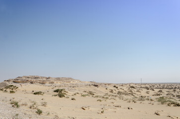Fototapeta na wymiar Desert landscape with limestone hillocks in the background