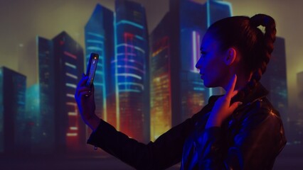 Portrait of cyberpunk girl with a smartphone. Beautiful young woman on the background of city scyscrapers. Futuristic concept. © Acronym