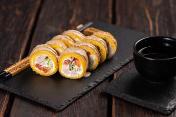 Roll with fish sushi with chopsticks - asian japanese food concept