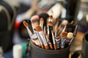 a jar full of assorted make-up brushes and brushes