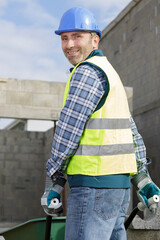 construction site work with concrete mixer and wheelbarrows