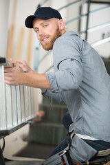 happy worker enters the ladder indoors