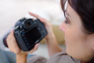 Woman checking her digital camera