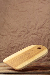 Cutting board falling on an old wooden table.