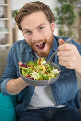 young man eating a healthy salad
