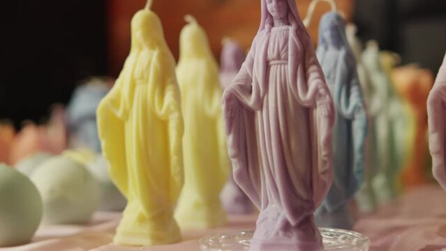 Handmade Virgin Mary colorful candles. High quality 4k footage