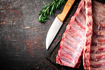 Raw ribs on a cutting board. 