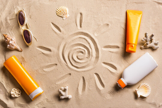 Sunblock products on sandy beach