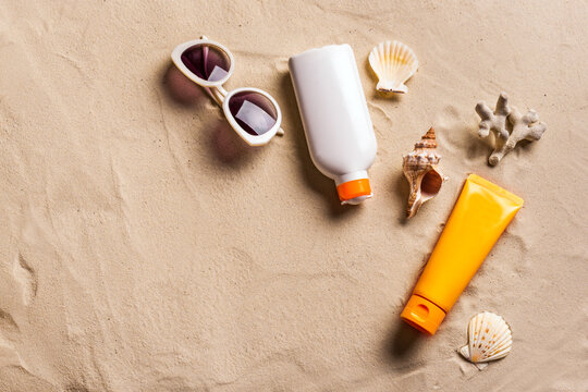 Sunblock products on sandy beach