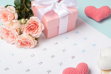 Calendar with the date of Valentine's day with roses and a gift