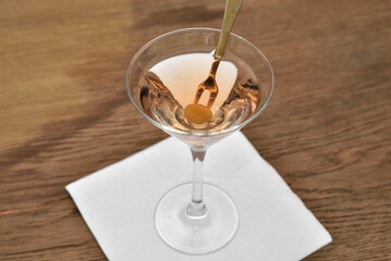 Wine glass of martini vermouth cocktail with olive.