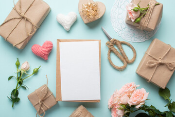 Fototapeta na wymiar Valentine's Day lay flat. Kraft envelope with a place for text on the background of eco gifts in kraft paper.