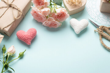 Banner for Valentine's Day. Romantic layout on a light blue background with roses, a gift and hearts.