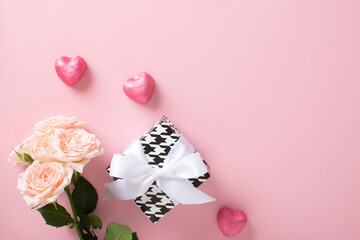 A mock-up of a Valentine's Day banner with a gift box, heart-shaped candies and a bouquet of roses on a pink background.