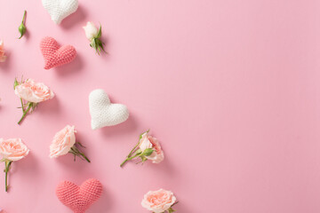 Valentine's Day background. Banner layout with roses and hearts on a light pink background with a space for text.