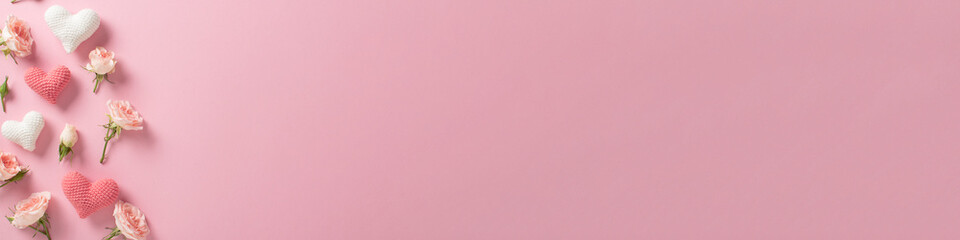 A long horizontal Valentine's Day banner. Banner layout with roses and hearts on a light pink background with a space for text.