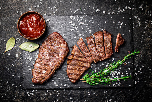 Grilled steak with a sprig of rosemary. 