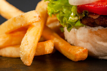 Abstract burger with meat french fries tomatoes onions and lettuce. Abstract fast food photo.