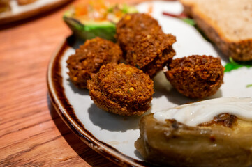 Healthy vegetarian food, vegan falafel balls served with grilles baked eggplant and grilled avocado