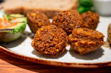 Healthy vegetarian food, vegan falafel balls served with grilles baked eggplant and grilled avocado