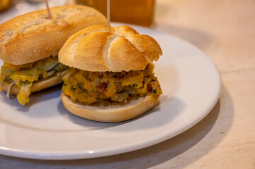 Typical mini burger snack of Basque Country, pinchos or pinxtos, small piece of bread with different toppings, served in bar in San-Sebastian or Bilbao, Spain