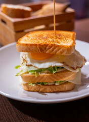 Vegetarian club sandwich with white bread, egg, green lettuce and cheese
