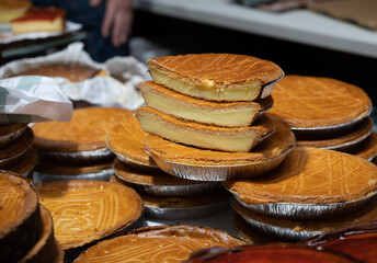 Sweet dessert of Basque Country, baked cheese cake with topping for sale on market in San...