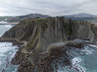View on steeply-tilted layers of flysch geological formation on Atlantic coast at Zumaia, Basque Country, Spain