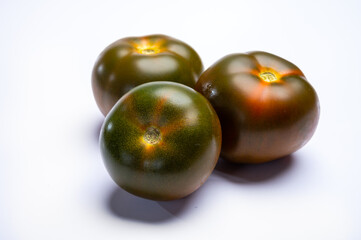Fresh ripe sweet reddish brown and green kumato tomatoes