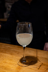 Pouring of txakoli or chacolí slightly sparkling very dry white wine produced in Spanish Basque Country in pinchos bar in old part of San Sebastian or Donostia, Spain