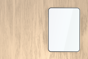 Tablet with empty screen on wooden desk, top view